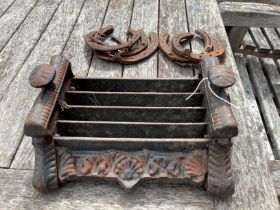 A Victorian style cast iron boot scraper, width 28cm together with six horseshoes