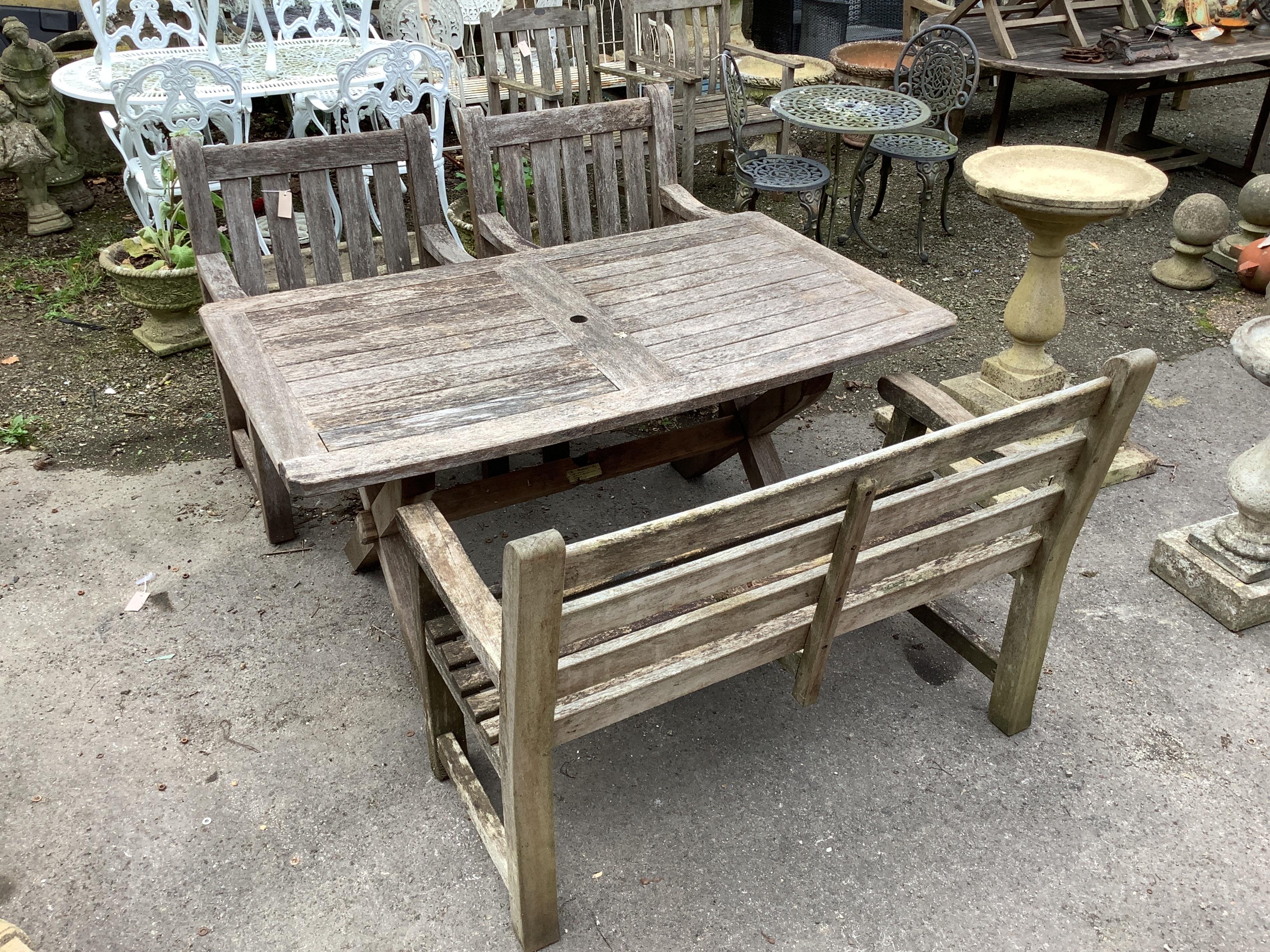 A rectangular weathered teak garden table, width 152cm, depth 86cm, height 74cm, together with a