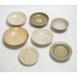 A group of seven Chinese Ding type, qingbai and celadon dishes, Song-Yuan dynasty, largest 15.5cm