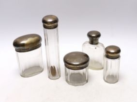 Five assorted silver topped toilet jars, London, 1911/12, largest 16.5cm.