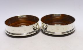 A pair of Elizabeth II silver mounted wine coasters, with turned wooden bases, Roberts & Dore,
