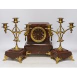 A late 19th century French rouge marble and ormolu clock garniture, 31cm