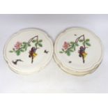 A set of eight late 19th century French Porcelain dessert plates decorated with scenes of figures on