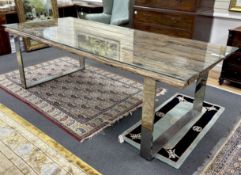A rustic rectangular driftwood dining table, on a stainless steel base with plate glass top,