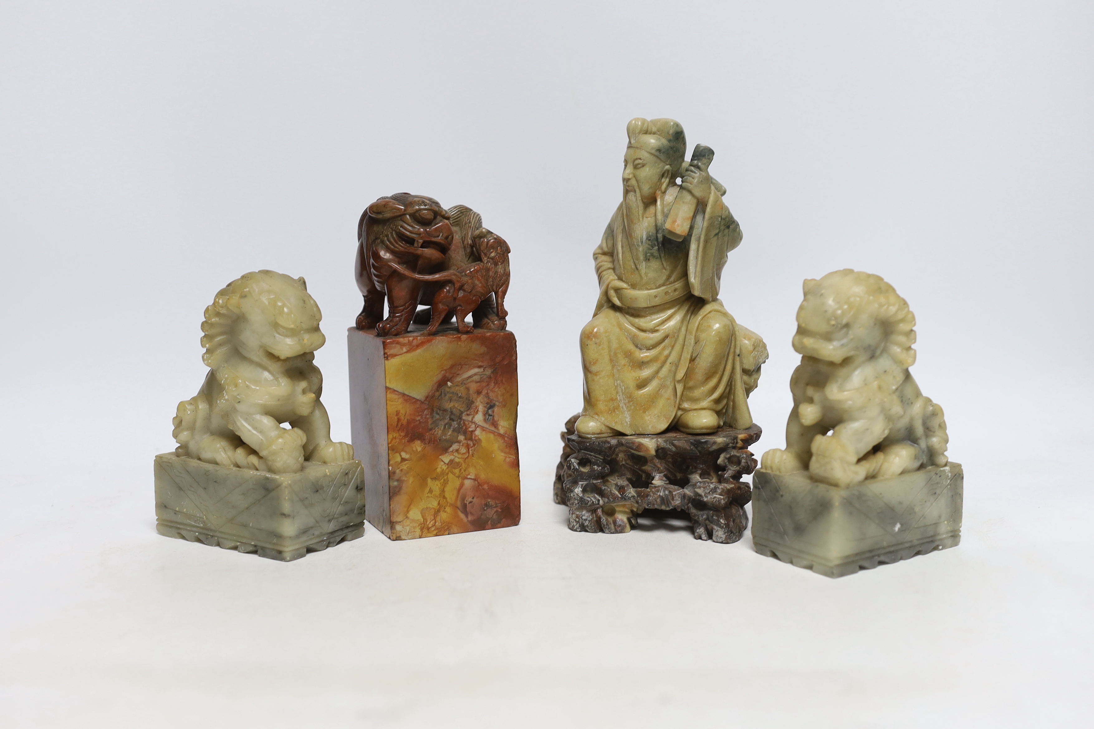 Two Chinese soapstone figures and a pair of Buddhist lion seals, tallest 19.5cm