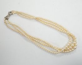 A triple strand graduated cultured pearl choker necklace, with diamond chip set 9ct white gold