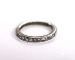 A white metal and channel set diamond full eternity ring, size J, gross weight 2.2 grams.