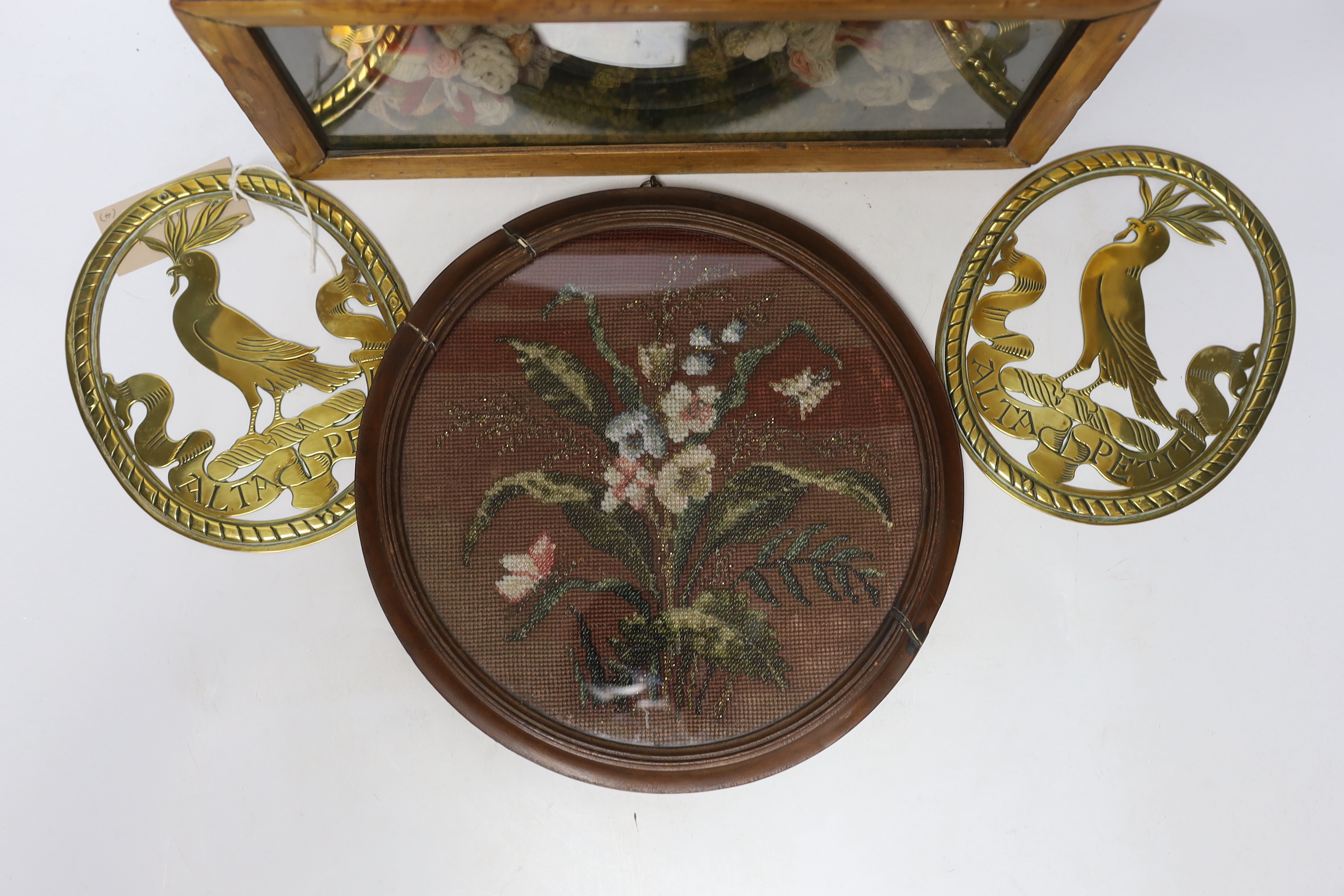 A pair of oval brass crests, a circular framed Berlin beadwork panel and a framed floral wool work - Image 2 of 3