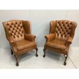 A pair of reproduction George III style buttoned pale brown leather wing armchairs, width 75cm,