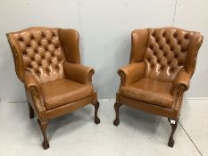 A pair of reproduction George III style buttoned pale brown leather wing armchairs, width 75cm,