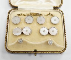 A cased eight piece 9ct, mother of pearl and diamond chip set dress stud set.