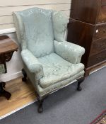 An early 20th century George III style upholstered wing armchair, width 82cm, depth 74cm, height