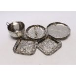 Chinese white metal items including two shaped dishes, a tea cup and two dragon dishes, largest 10.