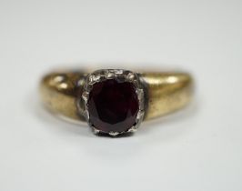 A yellow metal and collet set solitaire ruby ring, size M, gross weight 3.2 grams.