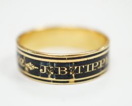 A George III yellow metal and black enamel set mourning band, inscribed ' J.B. Tippetts ob.28