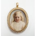 An Edwardian unmarked yellow metal and half pearl oval double sided pendant each side containing a