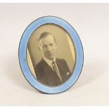 A George V silver and blue guilloche enamel mounted oval easel photograph frame, Goldsmiths &