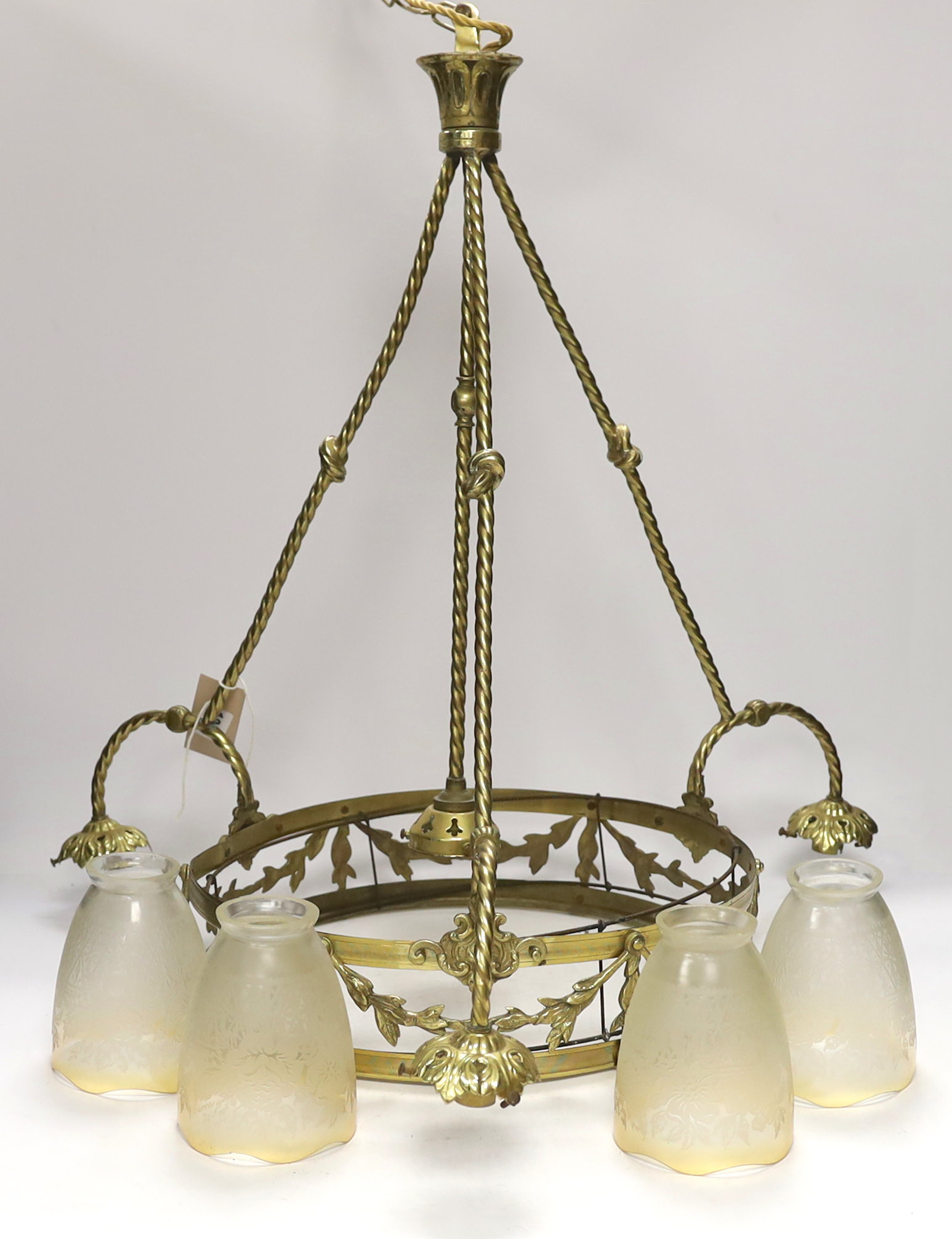 A brass three branch (four light) electrolier and four etched glass shades, 64cm high