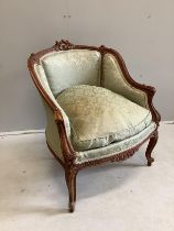 A Louis XVI style carved walnut small bergere chair, width 63cm, depth 53cm, height 76cm