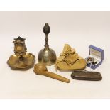 A group of collectables including a bell, a matchbox holder, a pendant, a brooch, etc.