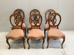 A set of six Victorian carved walnut balloon back dining chairs