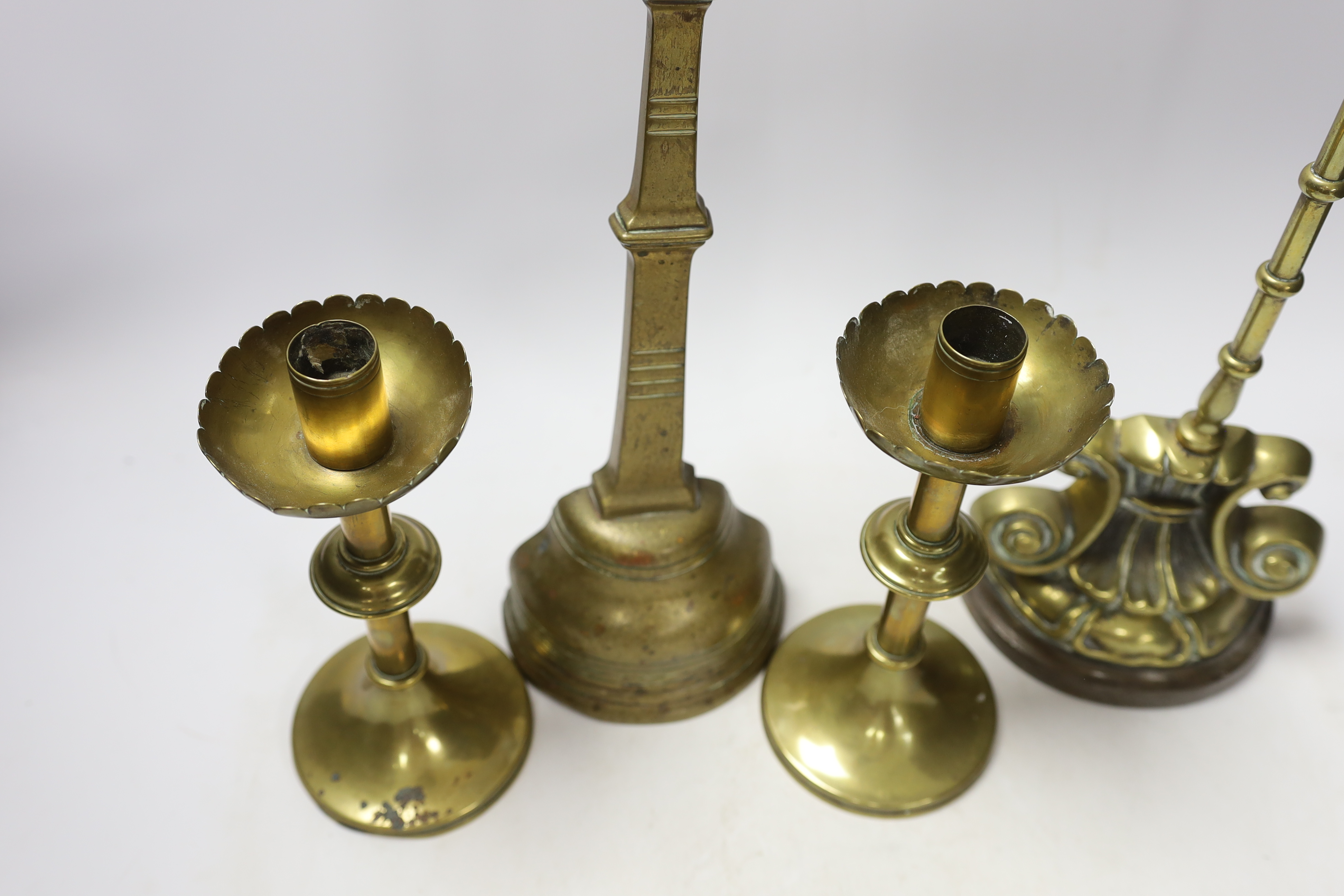 Two 19th century brass door porters and a pair of Gothic Revival brass candlesticks, 37cm (4) - Image 2 of 3