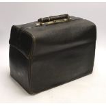 A black leather Gladstone bag
