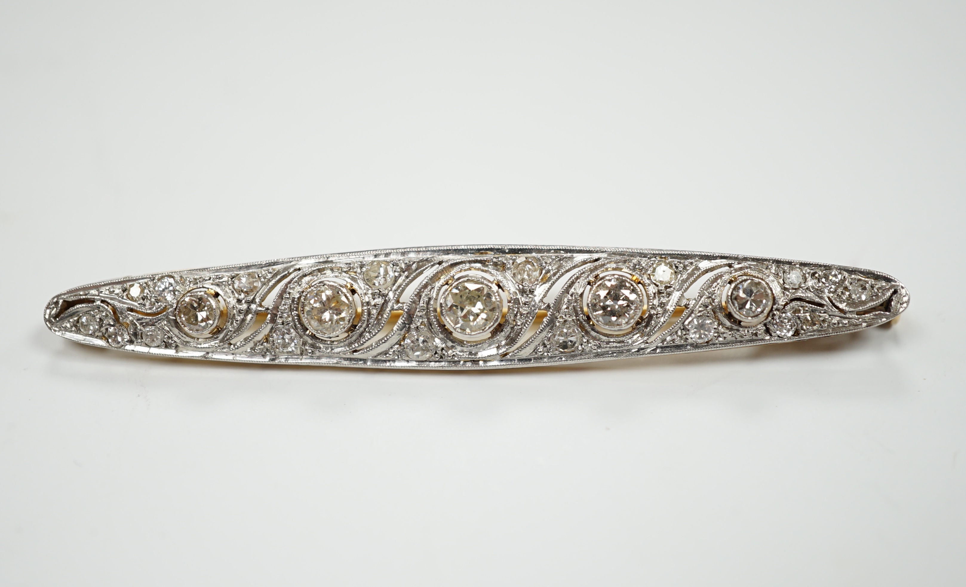 A Belle Epoque pierced white and yellow metal, diamond cluster set navette shaped bar brooch,