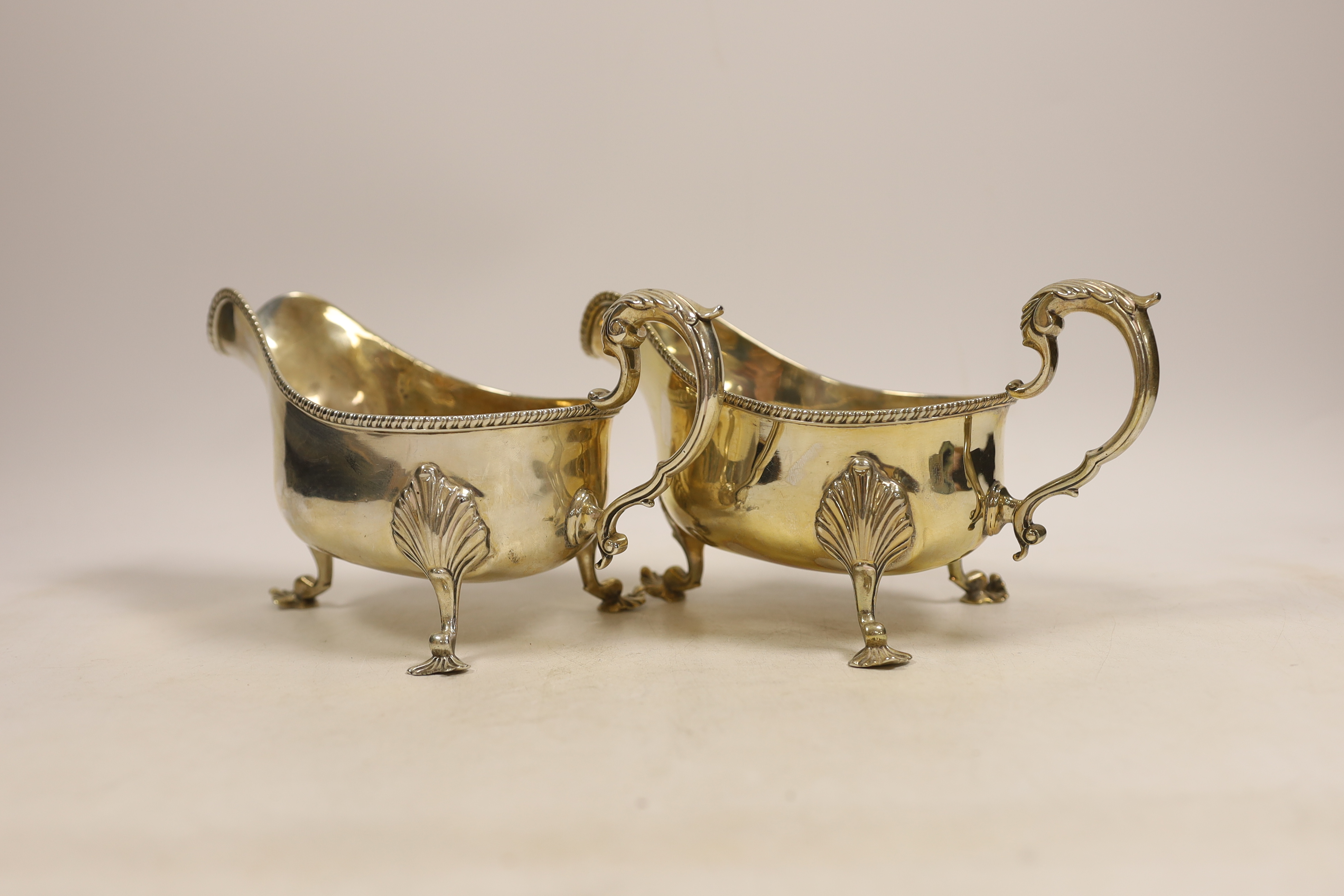 A pair of late Victorian silver sauceboats with gadrooned edge, double scroll handles on three shell - Image 2 of 3