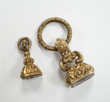 Two 19th century yellow metal overlaid and gem set fob seals, the largest with matrix carved with