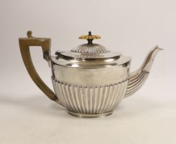 An Edwardian demi-fluted silver oval teapot, by Charles Stuart Harris, London, 1901, gross 16.5oz.