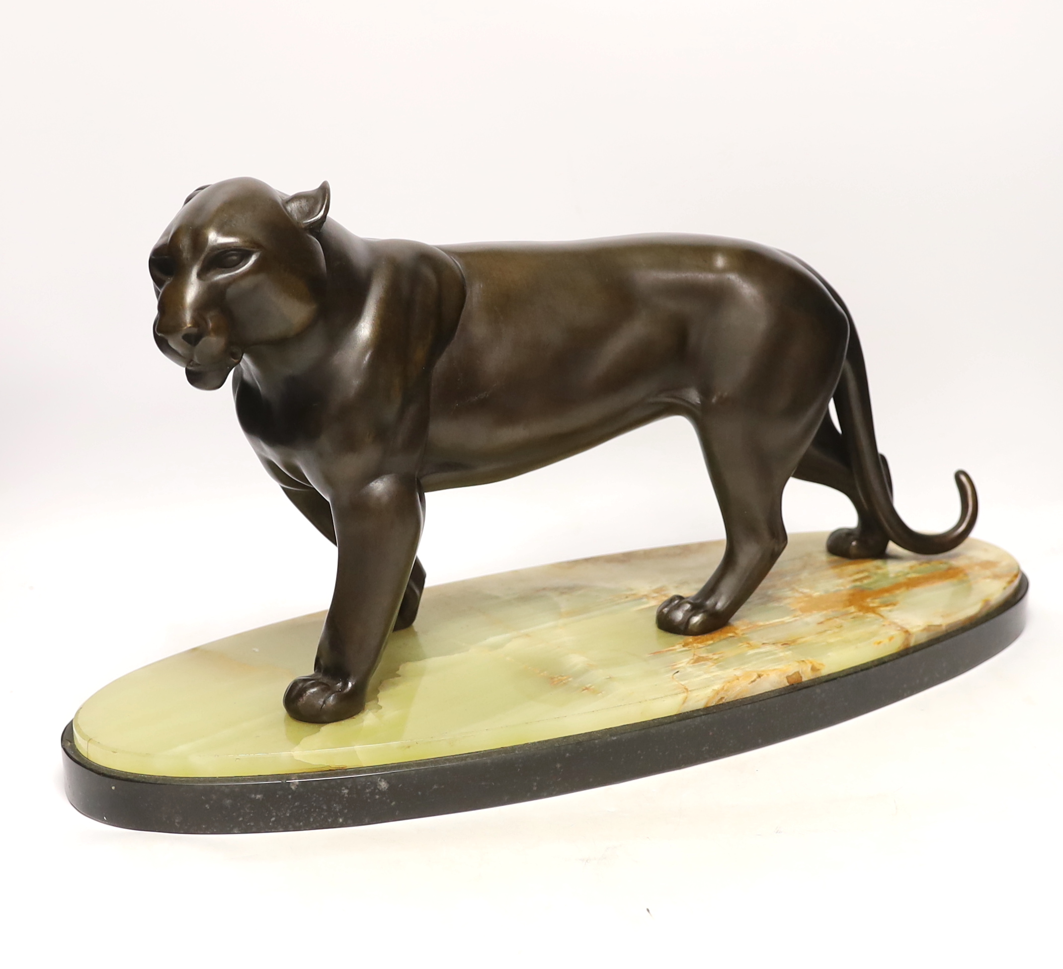 An Art Deco bronzed spelter figure of a panther, attributed to Rochard, on marble base, 56cm long