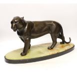 An Art Deco bronzed spelter figure of a panther, attributed to Rochard, on marble base, 56cm long