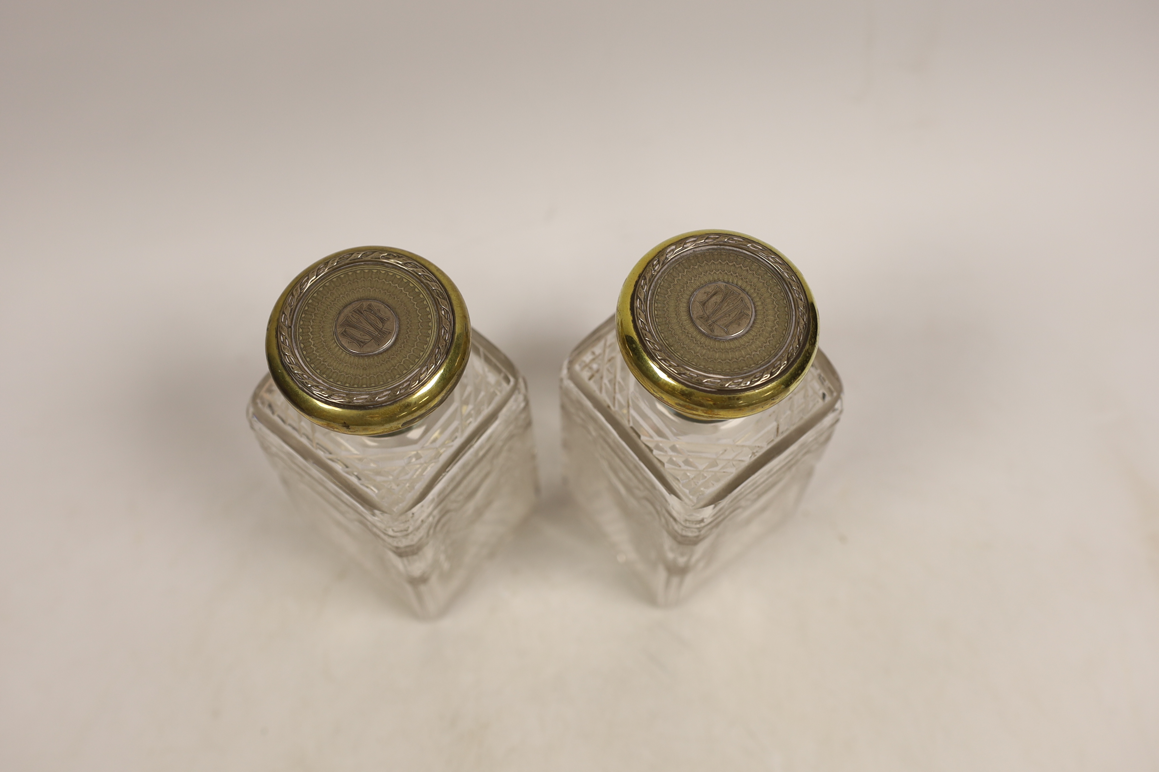 A pair of George V silver gilt mounted cut and etched glass square scent bottles and stoppers, - Image 2 of 4