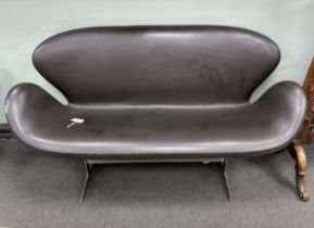 In the manner of Arne Jacobsen, a dark brown leather and chrome Swan sofa, width 142cm, depth