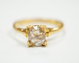 A yellow metal (stamped 22) and solitaire oval facet cut diamond set ring, size M, gross weight 2.