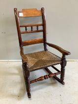 A 19th century fruitwood child's rush seat rocking chair, width 46cm, height 78cm