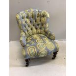 A late Victorian nursing chair, recently re-upholstered in a contemporary retro-style fabric,