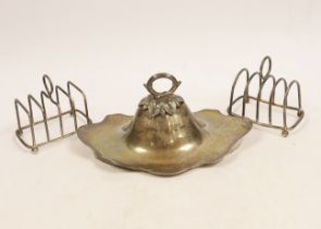 Two small silver four division wirework toast racks and a silver cover with handle, 6.6oz.