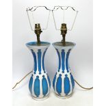 A pair of Bohemian overlaid glass vases, mounted as lamps,