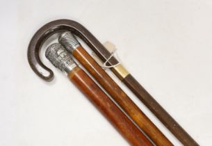 A 9ct gold mounted walking stick from Harrods and two white metal mounted malacca canes