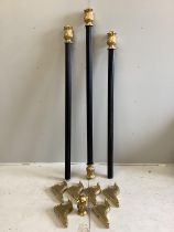 A set of three Regency style carved giltwood and ebonised curtain poles with brackets, largest