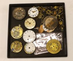 A small quantity of pocket watch accessories, including movements, dials and watch keys.