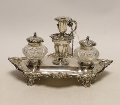 A Victorian silver inkstand, with two mounted glass wells and central removable chamberstick, John