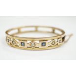 An Edwardian yellow metal, sapphire and diamond set hinged bangle, interior diameter 55mm, gross