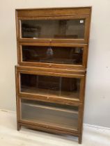 A Gunn glazed oak four section bookcase, width 86cm, depth 31cm, height 156cm