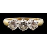 A modern 18ct gold and three stone diamond set ring, the three round brilliant cut stones with a