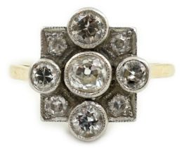 A 1920's/1930's 18ct gold, platinum and millegrain set nine stone diamond cluster ring, the