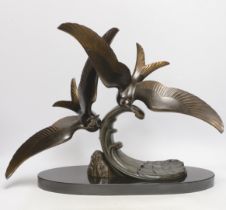 An Art Deco patinated spelter seagull group, signed Trebig, raised on slate base, 48cm wide