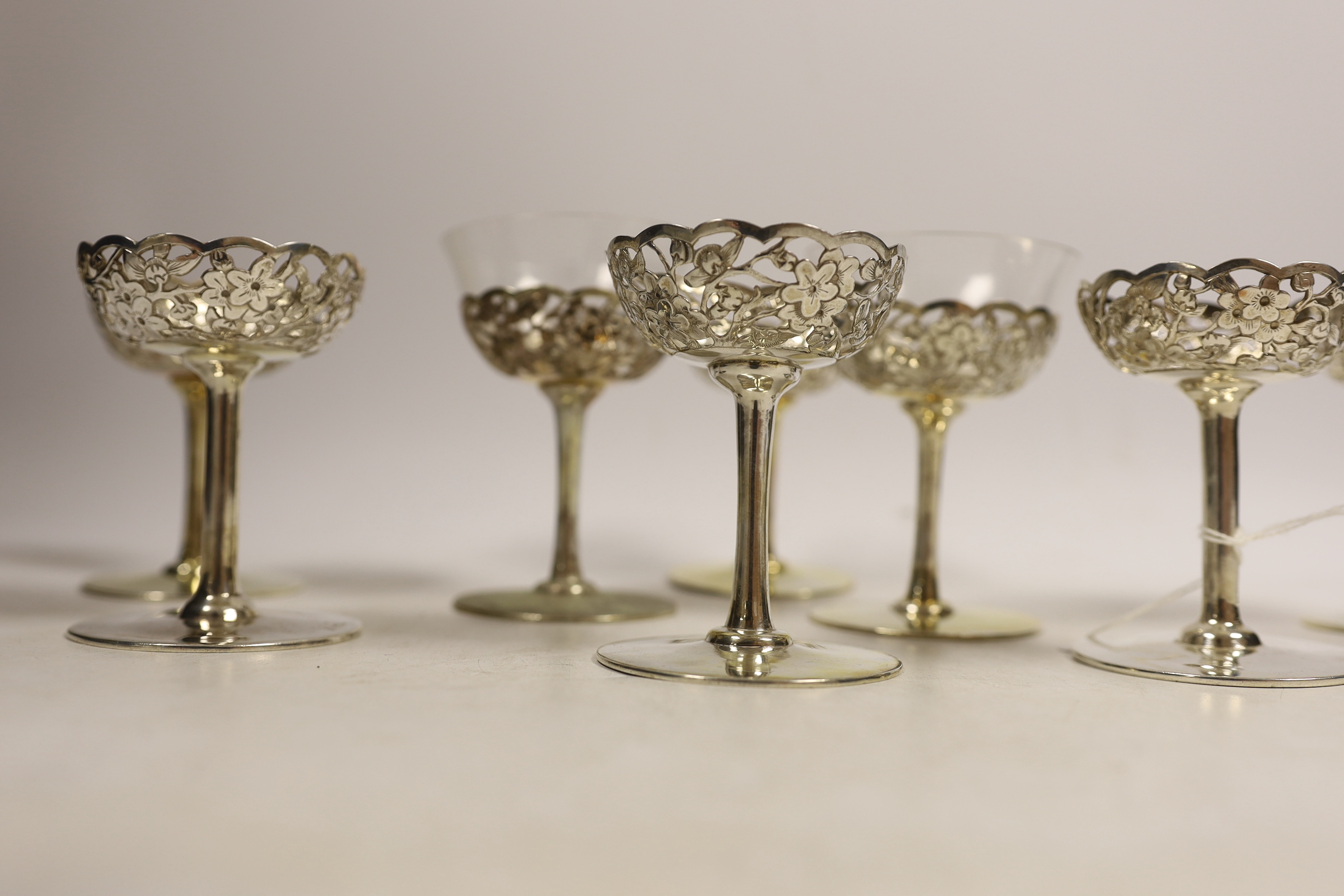 A matched set of eight pierced white metal coupes, two with glass inserts, six stamped with - Image 2 of 4